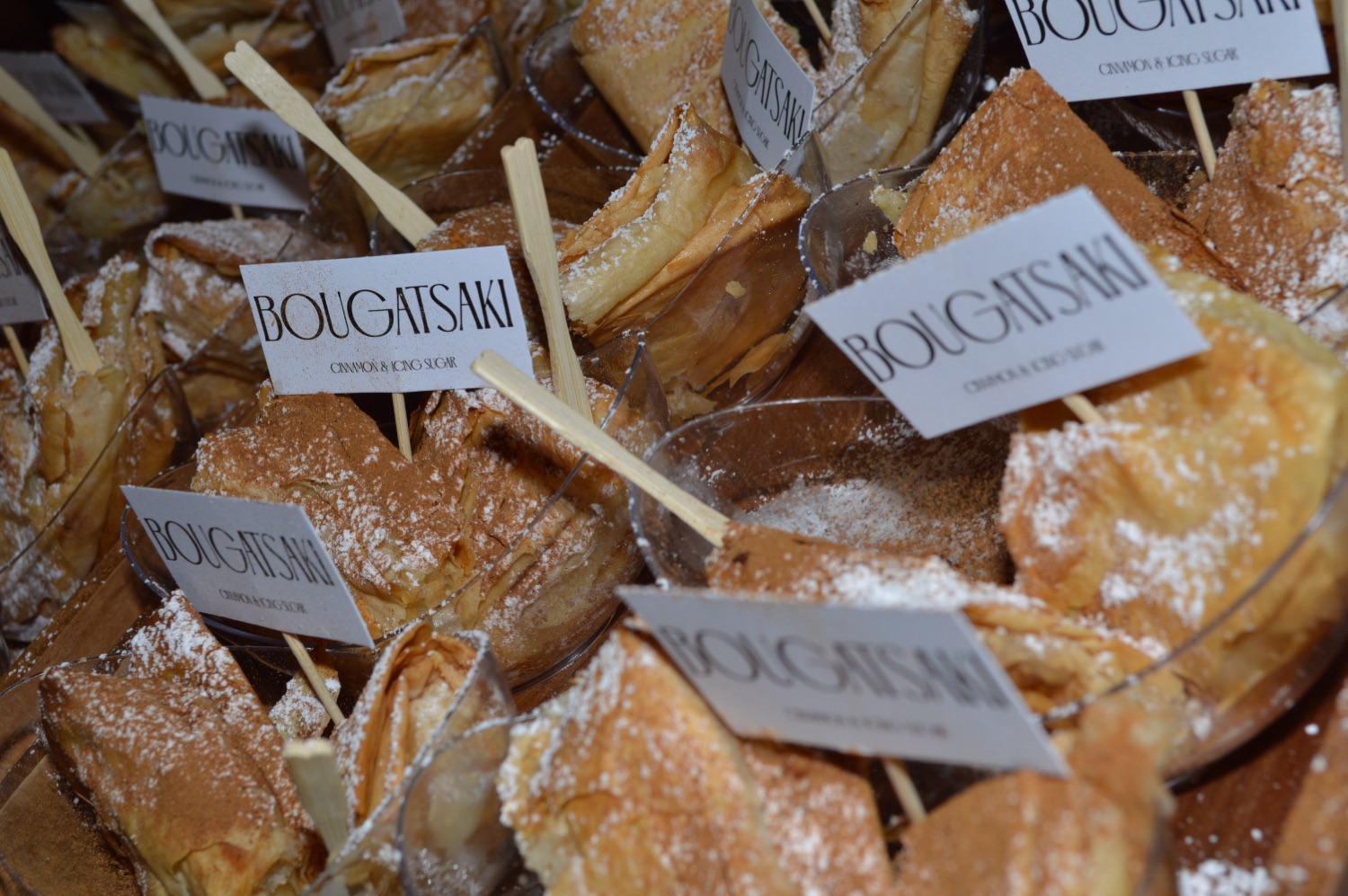 Bougatsa dessert bar with branded flags at an event