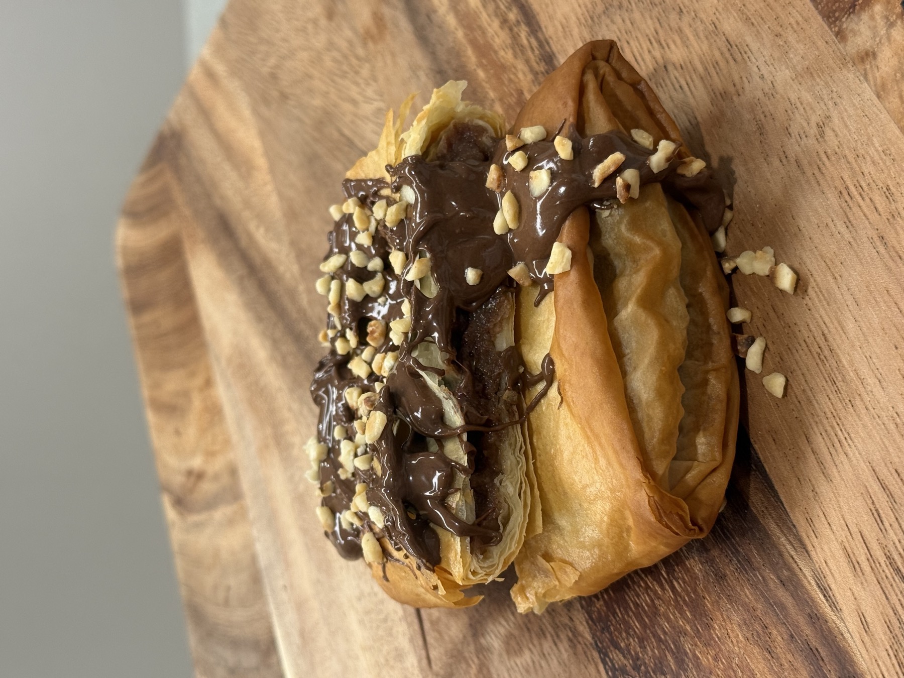 Nutella bougatsa — warm flaky filo with a swirl of Nutella, dusted with icing sugar
